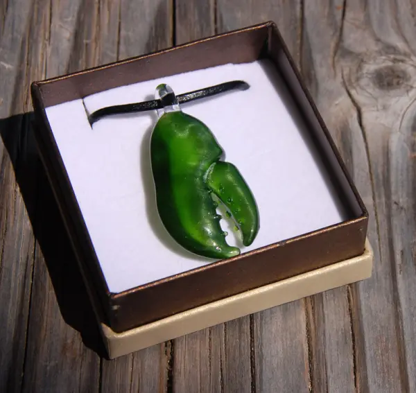 Hand-blown glass lobster claw pendant sold in the Dock Store